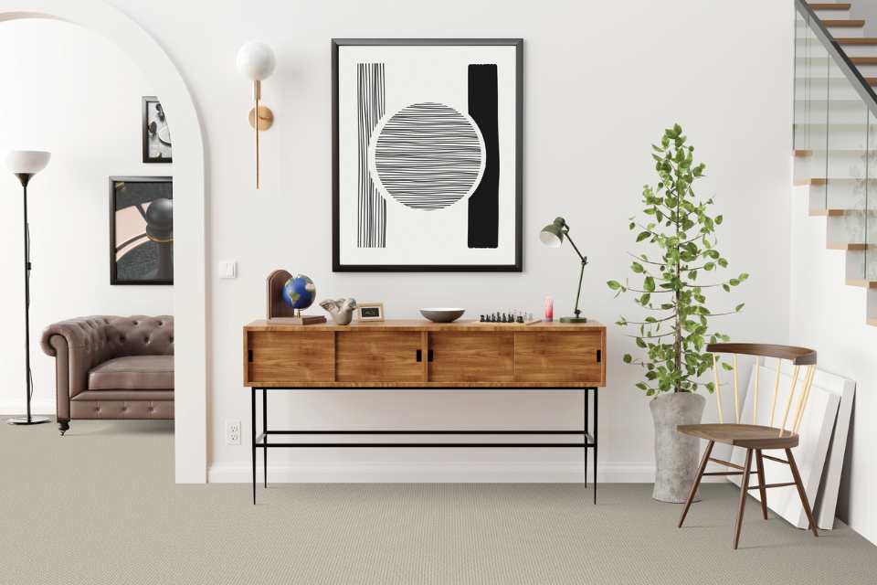 gray patterned carpet in mid century modern entryway with staircase and arched door